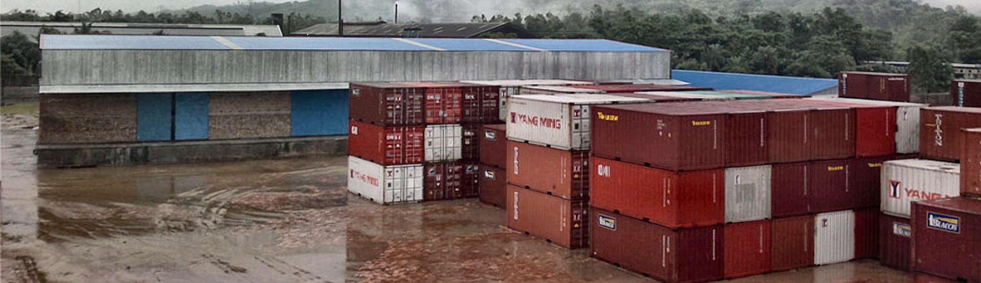 CCTCL warehouse beside rows of stacked containers